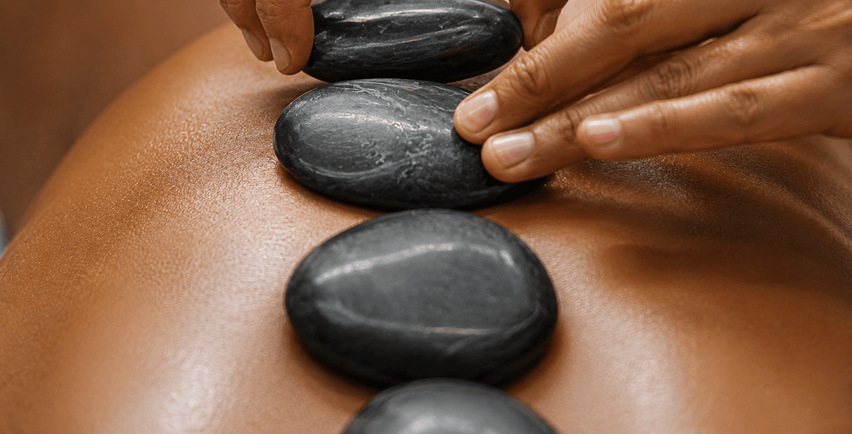Hot stones placed along a back during a healing massage